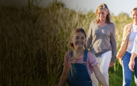 Family walking through field