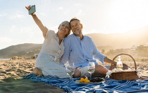 Beautiful happy senior couple dating at the seaside during summertime
