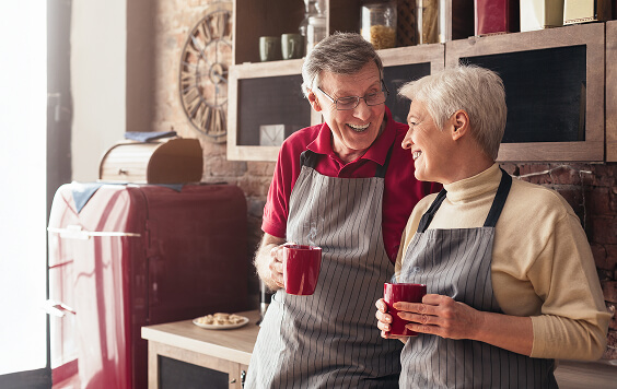 Older couple drinking form their mugs