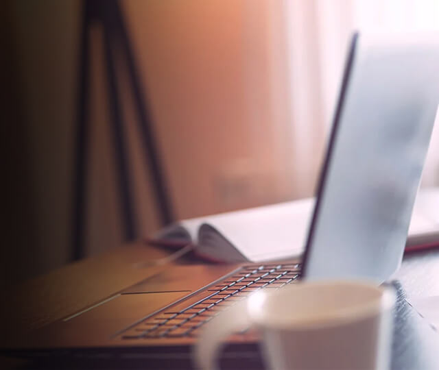 Desktop with pens laptop and mug