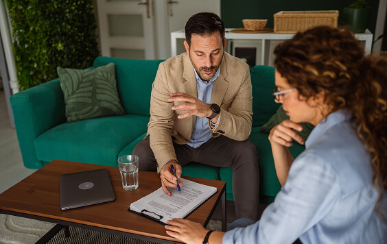 Man chatting with women at a table