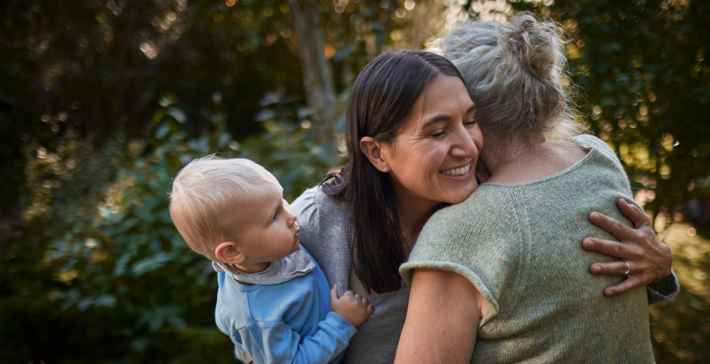 Mother with child embracing a lady