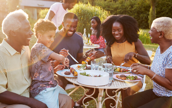 Family eating dinner outside in the sun