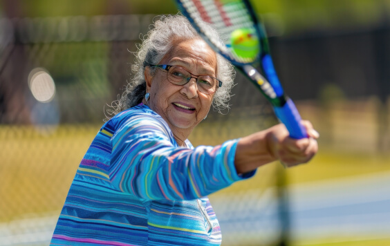 A woman of retirement age playing tennis