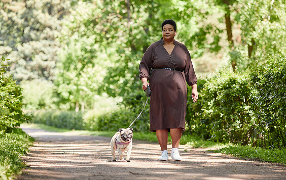 Woman walking her dog outside