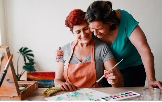 Two females doing some painting