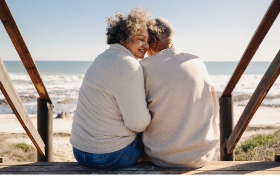 An older couple looking out onto the beach