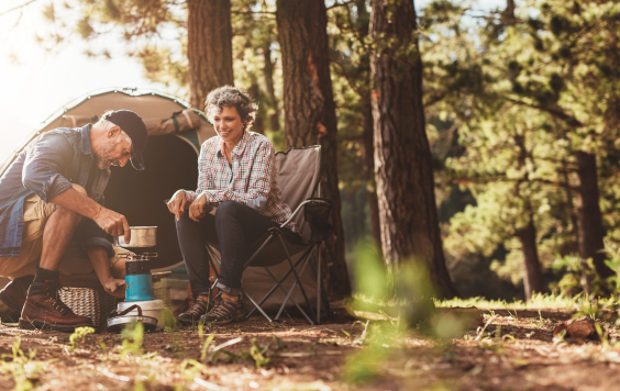 Older couple camping outside