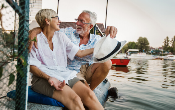 Older couple sitting by a river