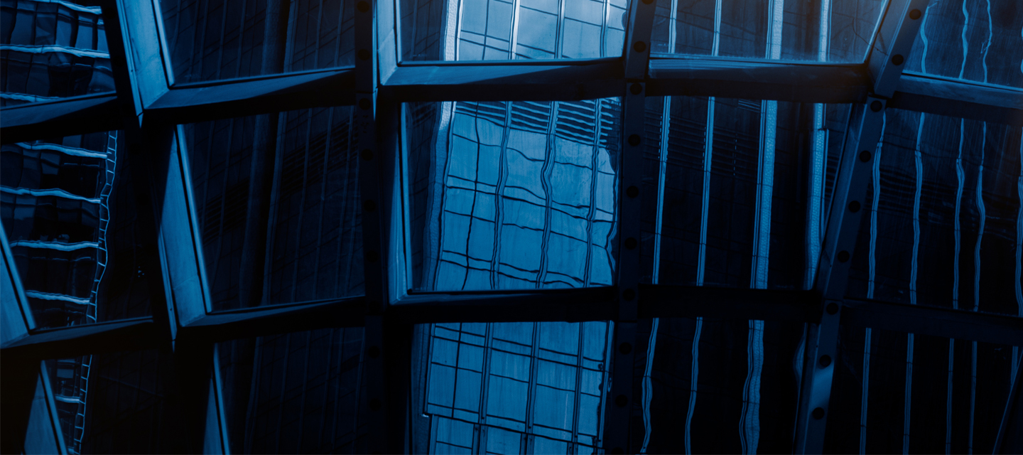 Dark blue windows with reflections of tall buildings